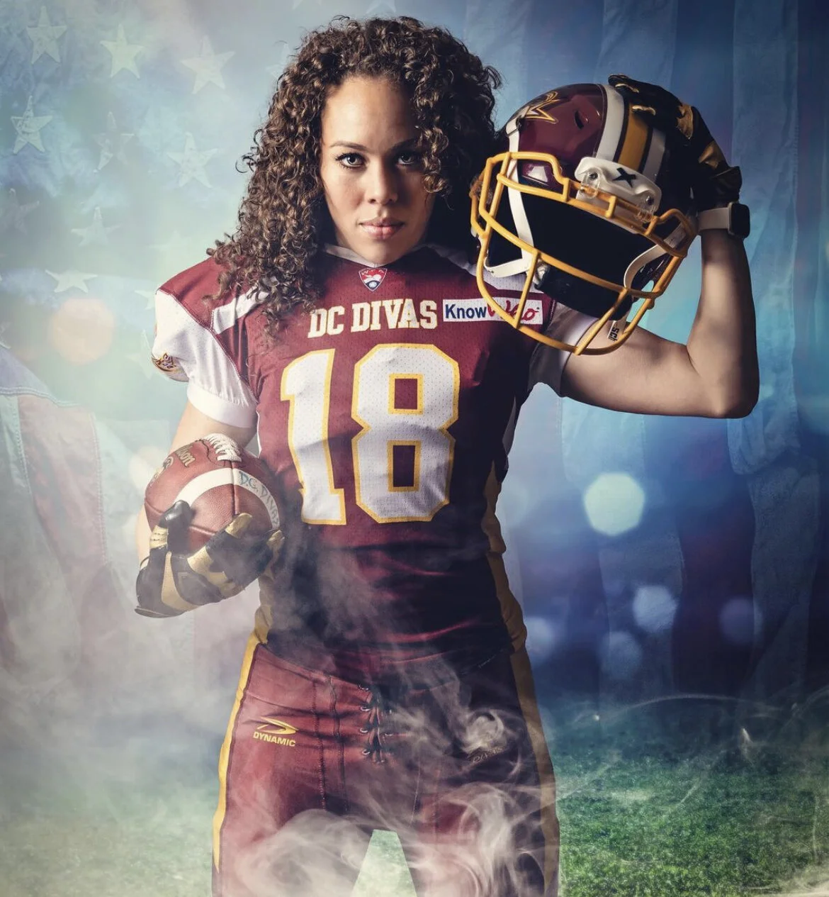 A female football player holding her helmet and a football